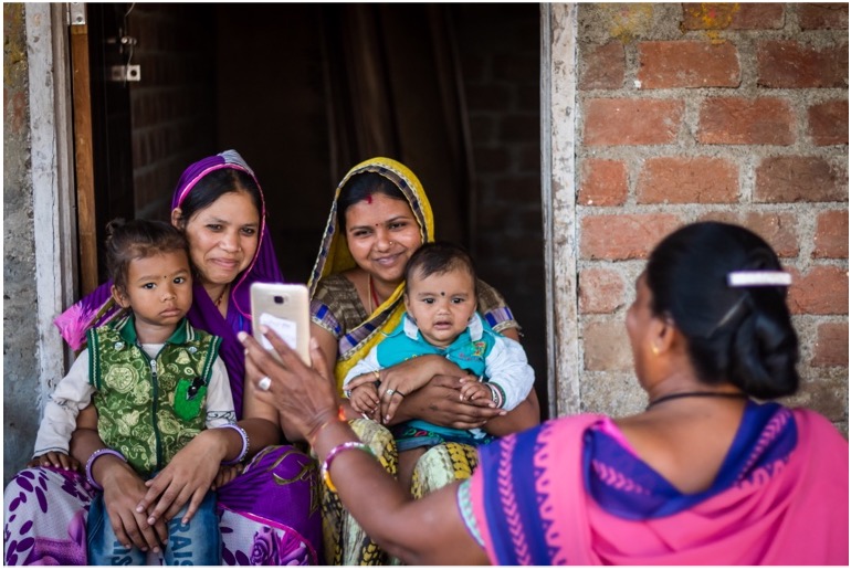 An Anganwadi showing the App to mothers