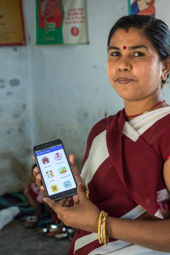 Community Health Worker using a phone